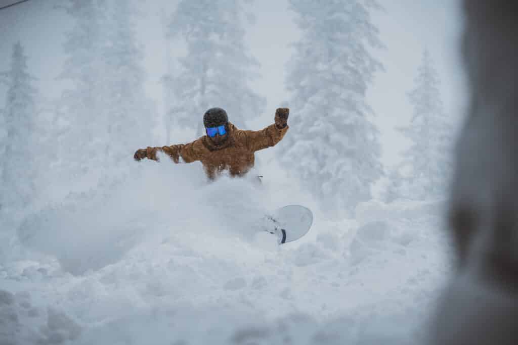 Snowboarder in deep powder at Arizona Snowbowl.