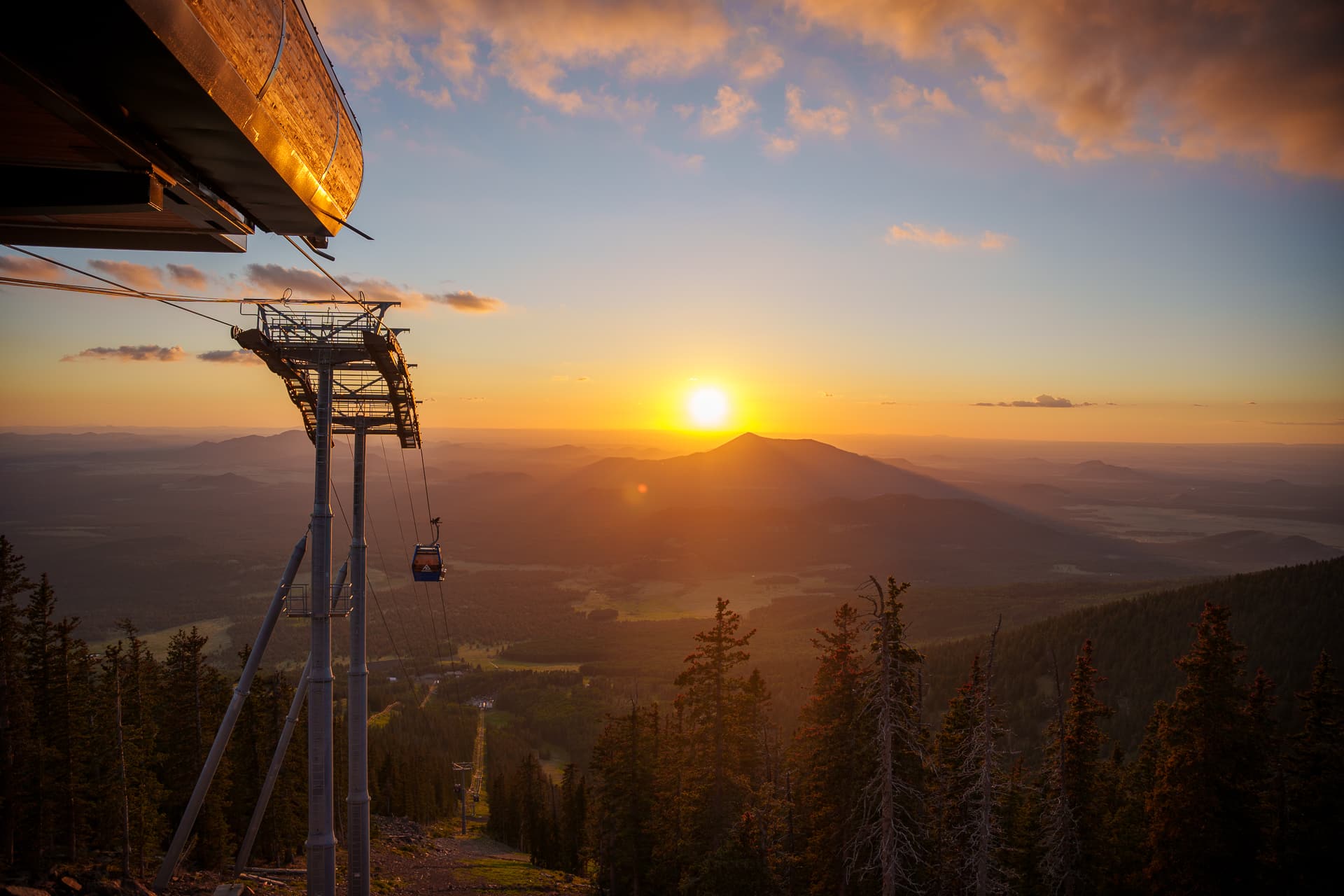 sun setting on landscape with the Arizona Gondola in view