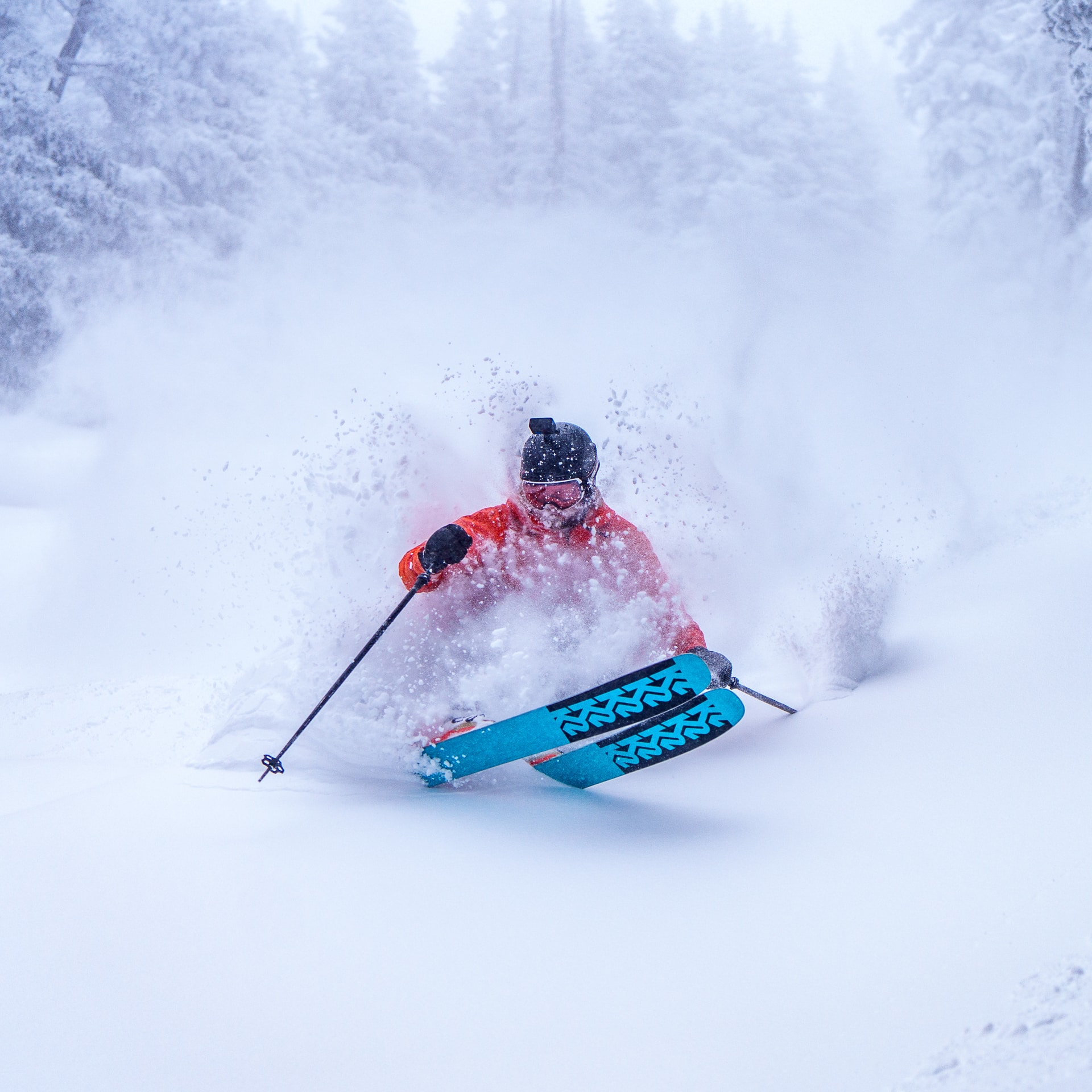 skier slashing through powder