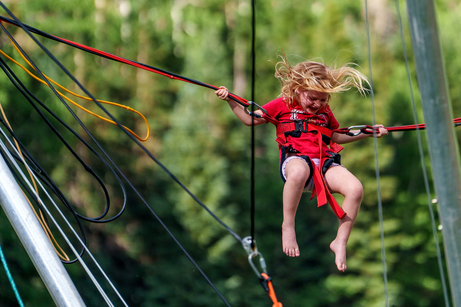 Cheerful child on bungee trampoline