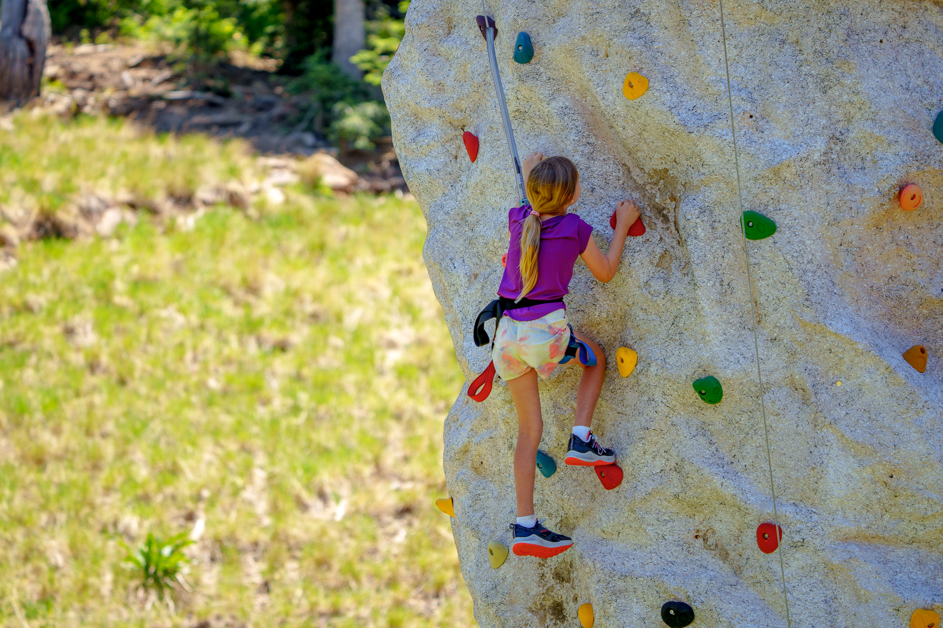 Girl on rock wall