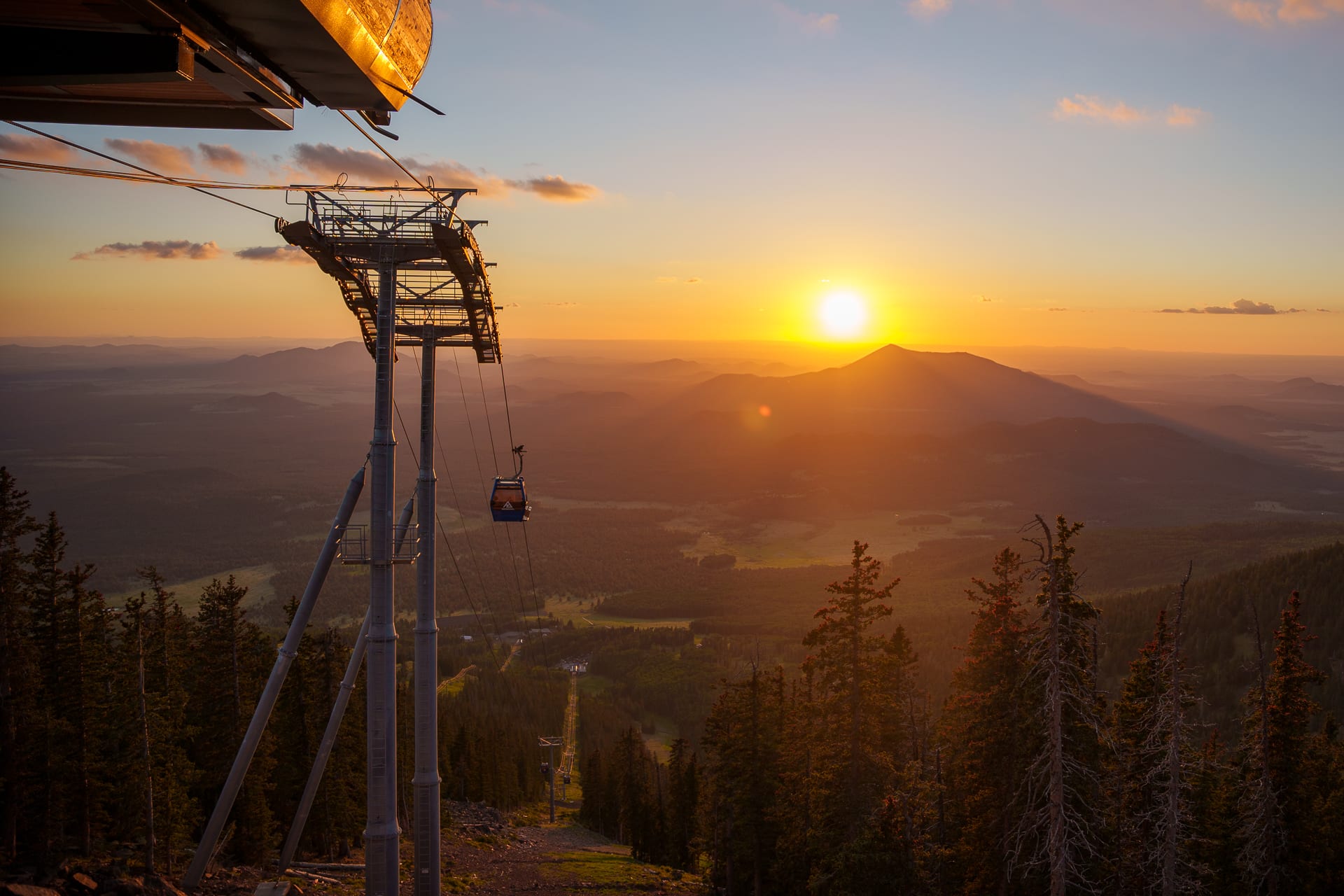 Sun setting on landscape with Arizona Gondola in view