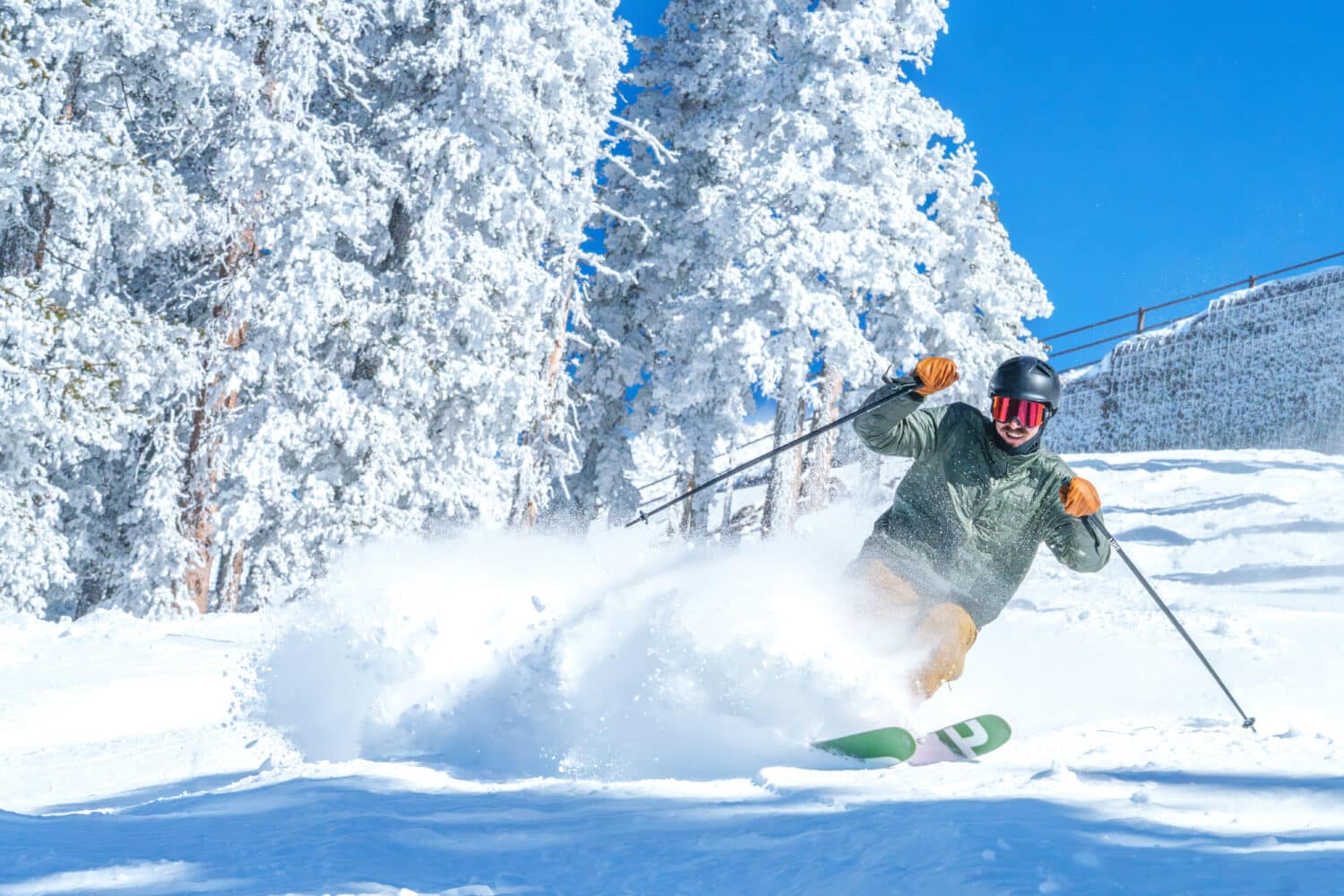 Skier spraying fresh snow at Snowbowl